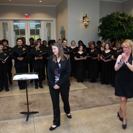 a group of people singing in a room