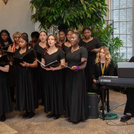 a group of women singing in a room