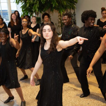 a group of people in black dresses