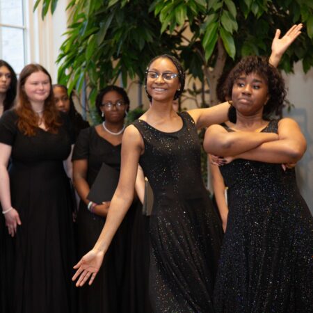 a group of women in black dresses
