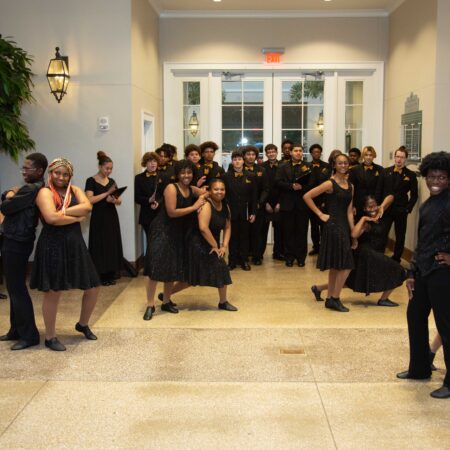 a group of people in black dresses
