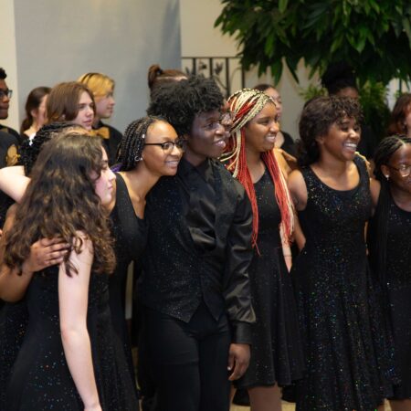 a group of people in black dresses
