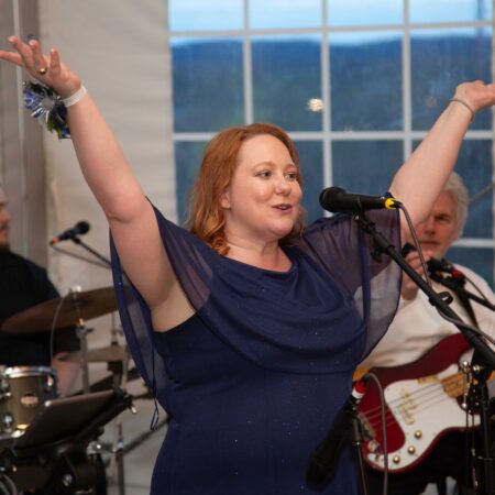a person with her arms up in the air