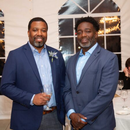 a couple of men standing together
