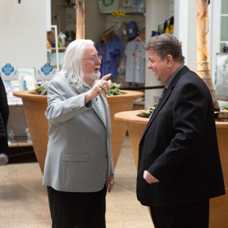 a person in a suit pointing at another person