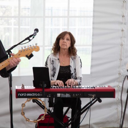 a person playing a keyboard and a person playing guitar