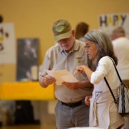 people looking at a piece of paper