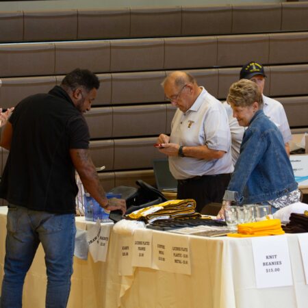 a group of people standing around a table
