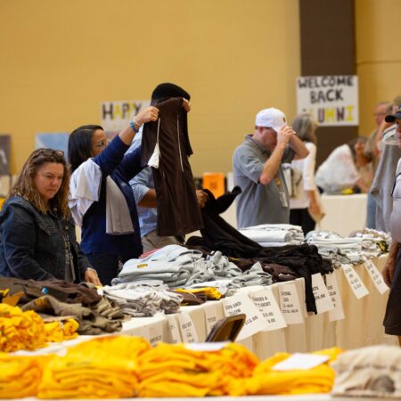 people looking at a table with clothes