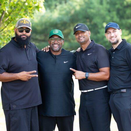 a group of men in black shirts and hats