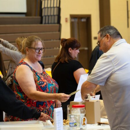 a group of people standing around a table
