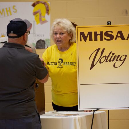 a person in a yellow shirt standing next to a person