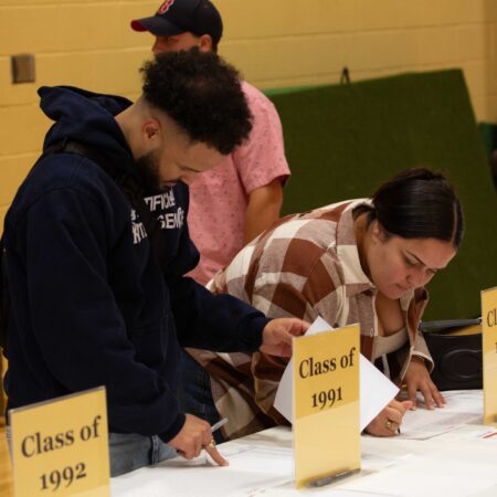 a group of people looking at papers