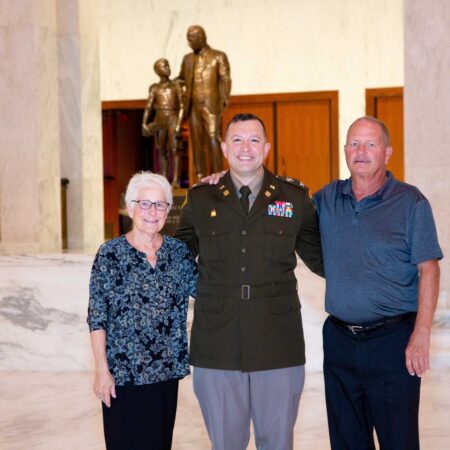 people standing in front of a statue