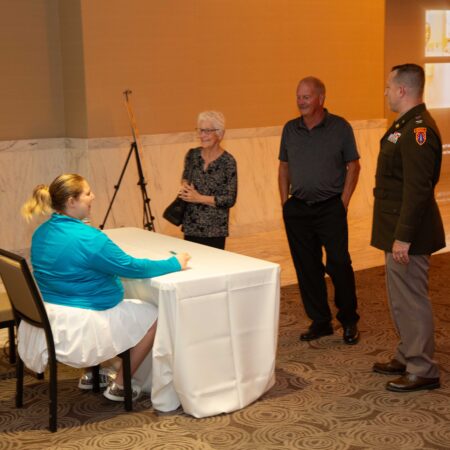 a person sitting at a table with a gun
