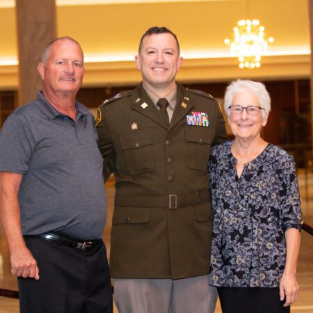 a person in a military uniform with a couple of people