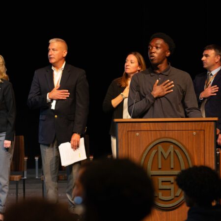a group of people standing at a podium