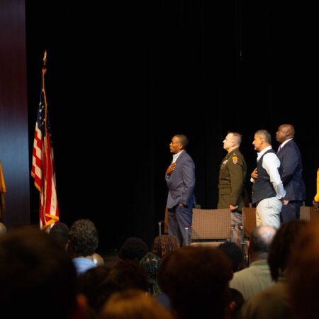 a group of men standing on stage