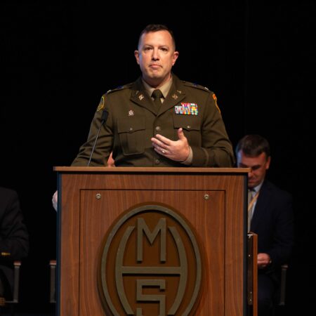 a person in uniform standing at a podium