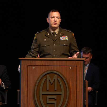 a person in uniform standing at a podium