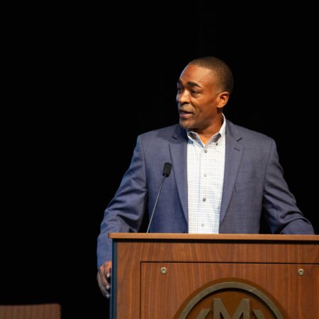 a person standing at a podium