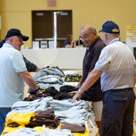 a group of men looking at clothes