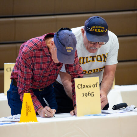 a group of men signing a paper