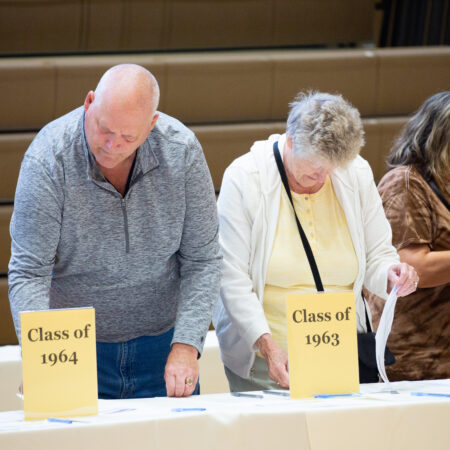 people at a table with signs