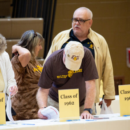 a group of people standing next to signs