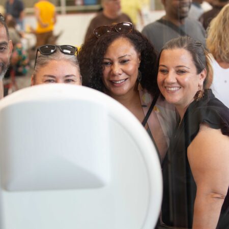 a group of people looking at a mirror