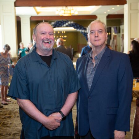 two men standing in a room