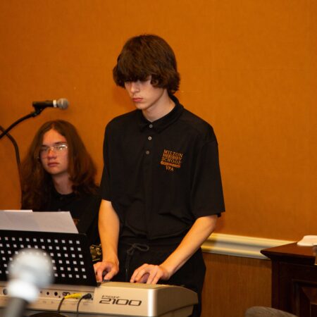 a person standing at a keyboard