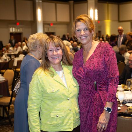 a couple of women standing together