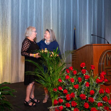 two women standing on a stage