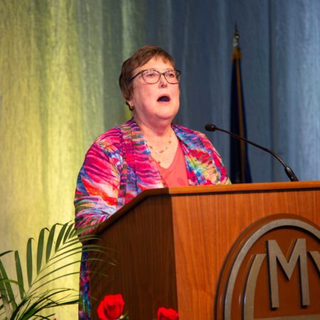 a person speaking at a podium