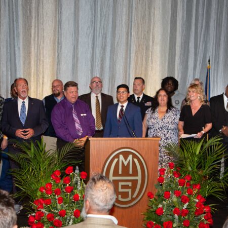 a group of people standing at a podium