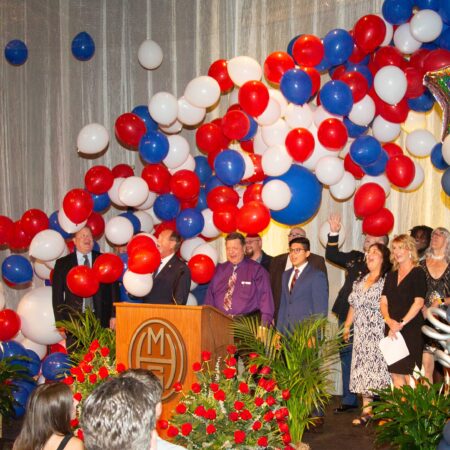 a group of people standing at a podium