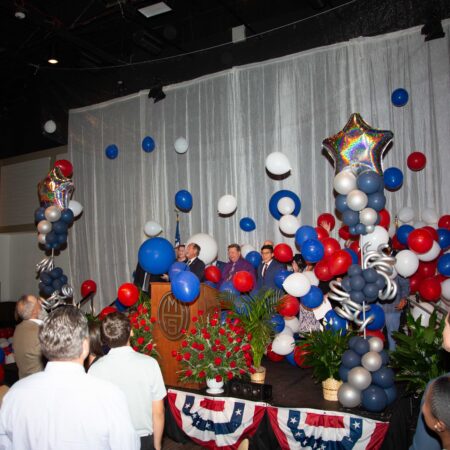 a group of people in a room with balloons