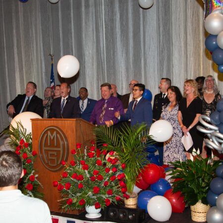 a group of people standing at a podium