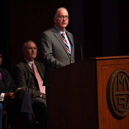 a person standing at a podium