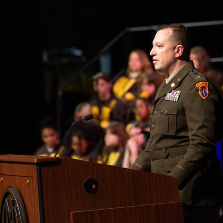 a person in uniform standing at a podium