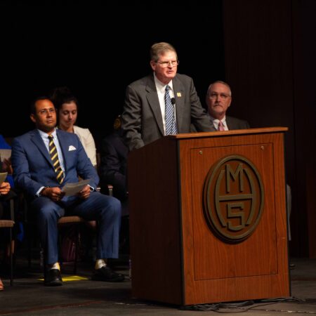 a person standing at a podium