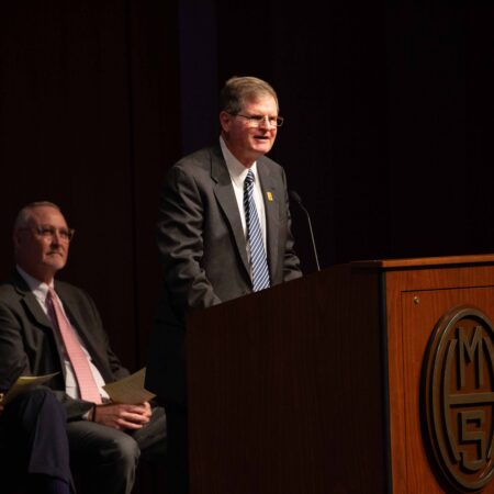 a person standing at a podium