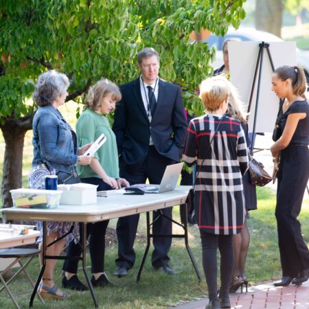 a group of people standing around a table