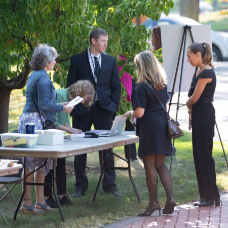 a group of people standing around a table