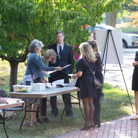 a group of people standing around a table