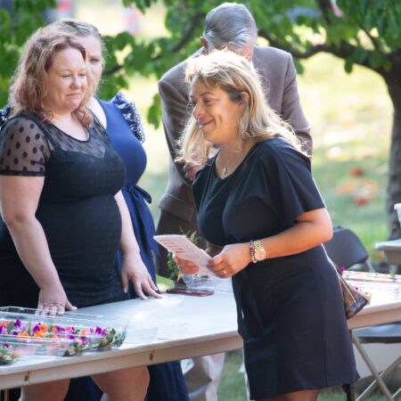 a group of women standing next to a table