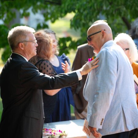 a person in a suit touching a person's chest