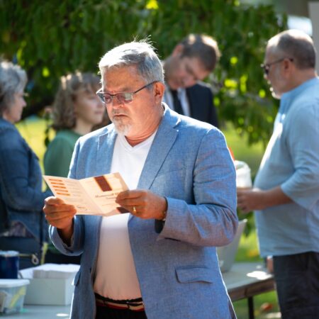 a person in a blue suit reading a paper