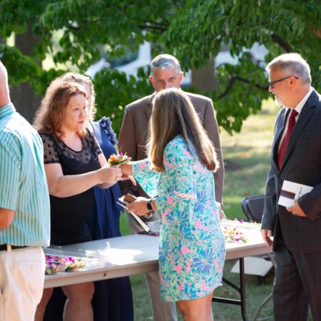 a group of people standing around a table